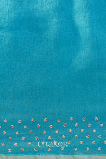 Detail of unstitched blouse piece and scattered sequin embroidery on turquoise navy Chanderi silk cotton saree.
