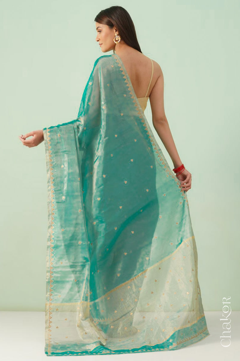 Back view of peacock blue Chanderi tissue silk cotton saree showing the tissue sheen and embroidered details.
