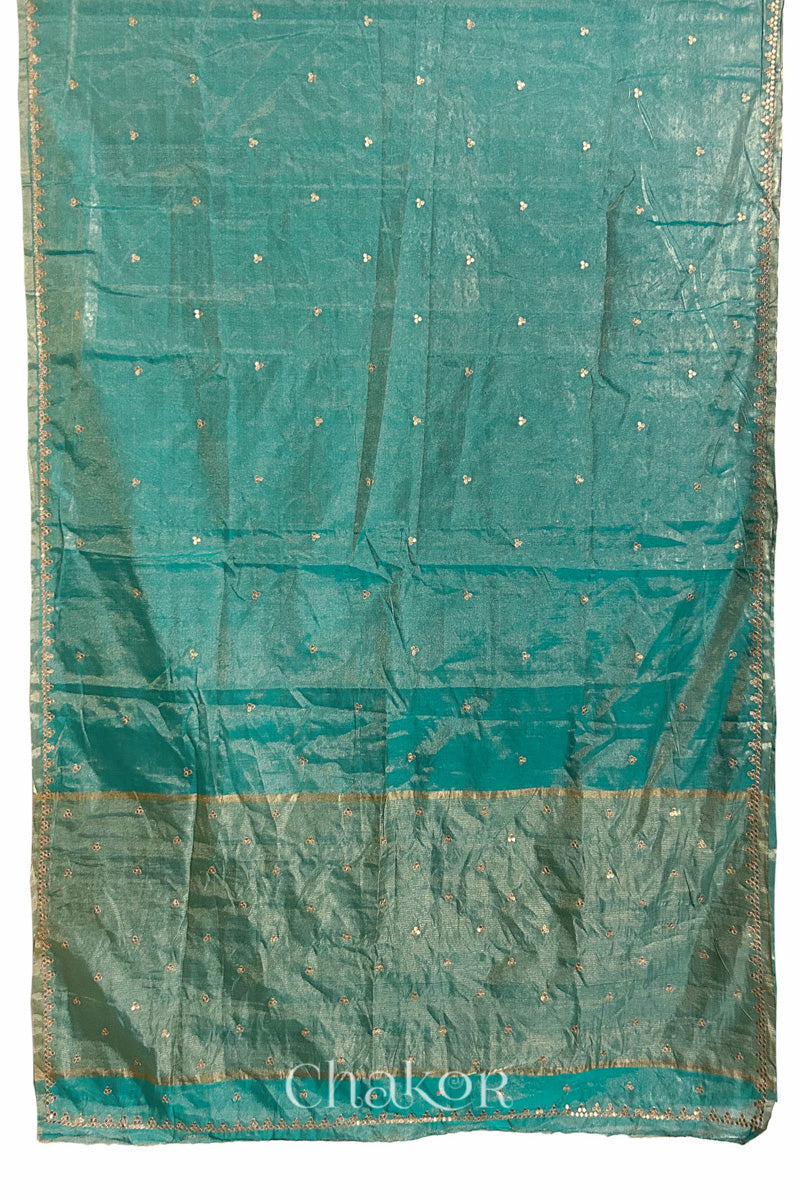 Full flatshot of peacock blue Chanderi tissue silk cotton saree with embroidered motifs and zari border.
