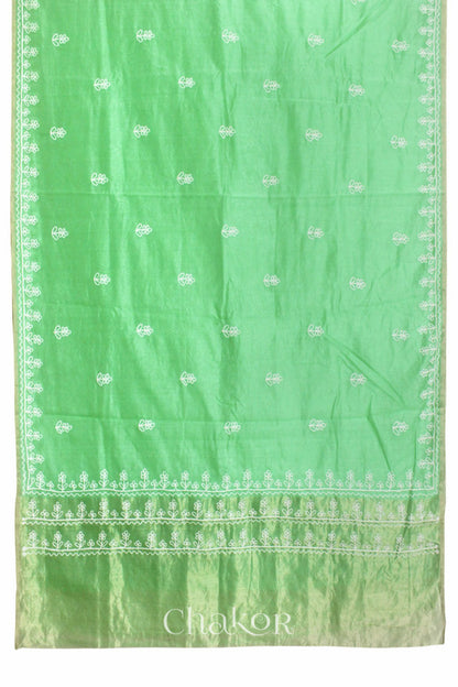 Flat view of sea green Chanderi silk cotton saree showing tissue pallu and aari embroidery.
