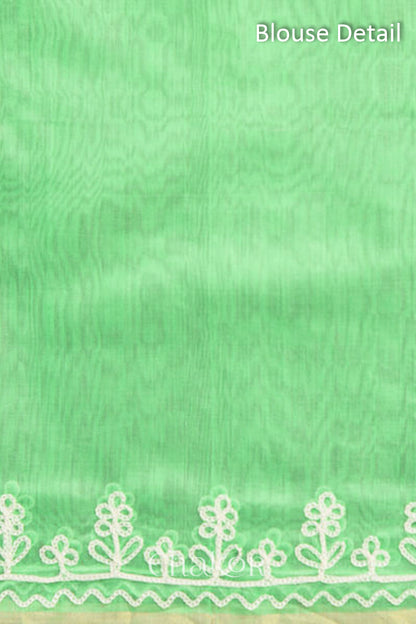 Blouse fabric detail in sea green Chanderi silk cotton with woven texture.
