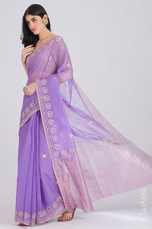Model wearing a lavender Chanderi silk cotton saree with tissue pallu and aari embroidered borders.
