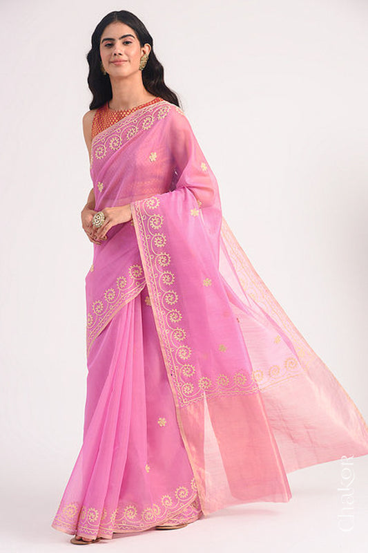Model wearing a pink Chanderi silk cotton saree with tissue pallu and aari embroidered borders.
