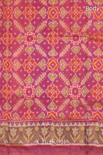 Close up of Handloom Pink Rajkoti Patola Ikat Mulberry Silk Saree with tissue borders, and mauve pallu woven using traditional designs in Gujarat.