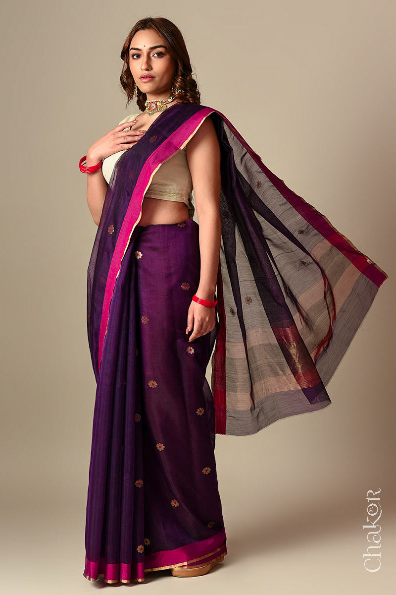 Model wearing a Wine Chanderi silk cotton saree with Ganga Jamuna borders and tissue-striped pallu.
