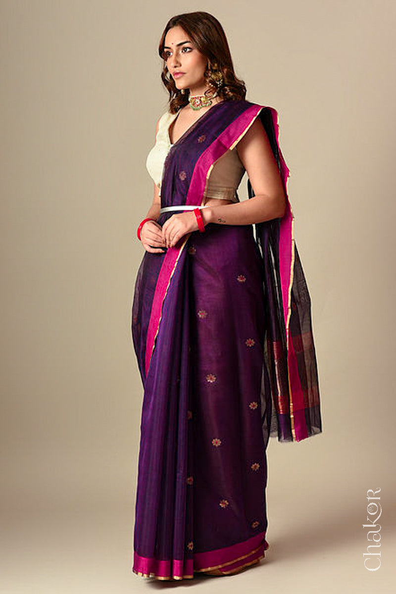 Model wearing a Wine Chanderi silk cotton saree with Ganga Jamuna borders and tissue-striped pallu.
