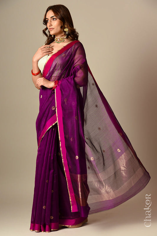 Model wearing a Magenta Chanderi silk cotton saree with Ganga Jamuna borders and tissue-striped pallu.
