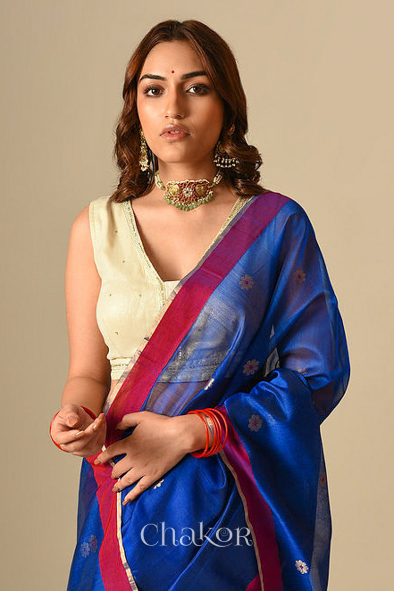 Model wearing Blue Chanderi silk cotton saree draped to show Ganga Jamuna borders and woven phool butti motifs.
