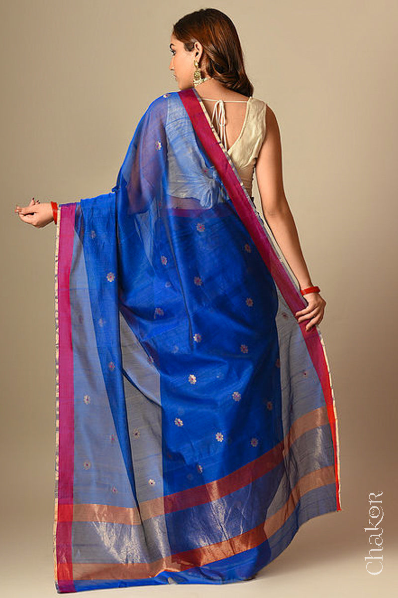 Back view of model wearing Blue Chanderi silk cotton saree with tissue-striped pallu displayed.
