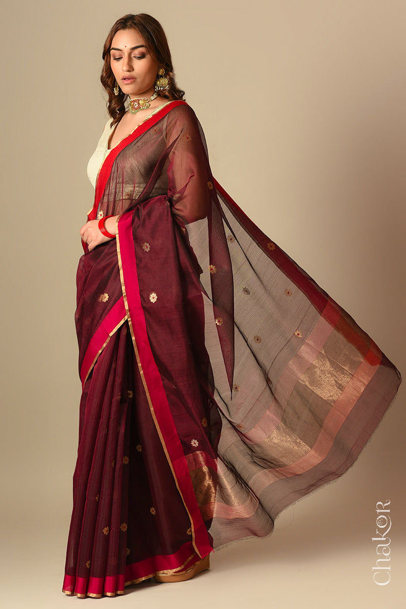 Model wearing a Maroon Chanderi silk cotton saree with Ganga Jamuna borders and tissue-striped pallu.
