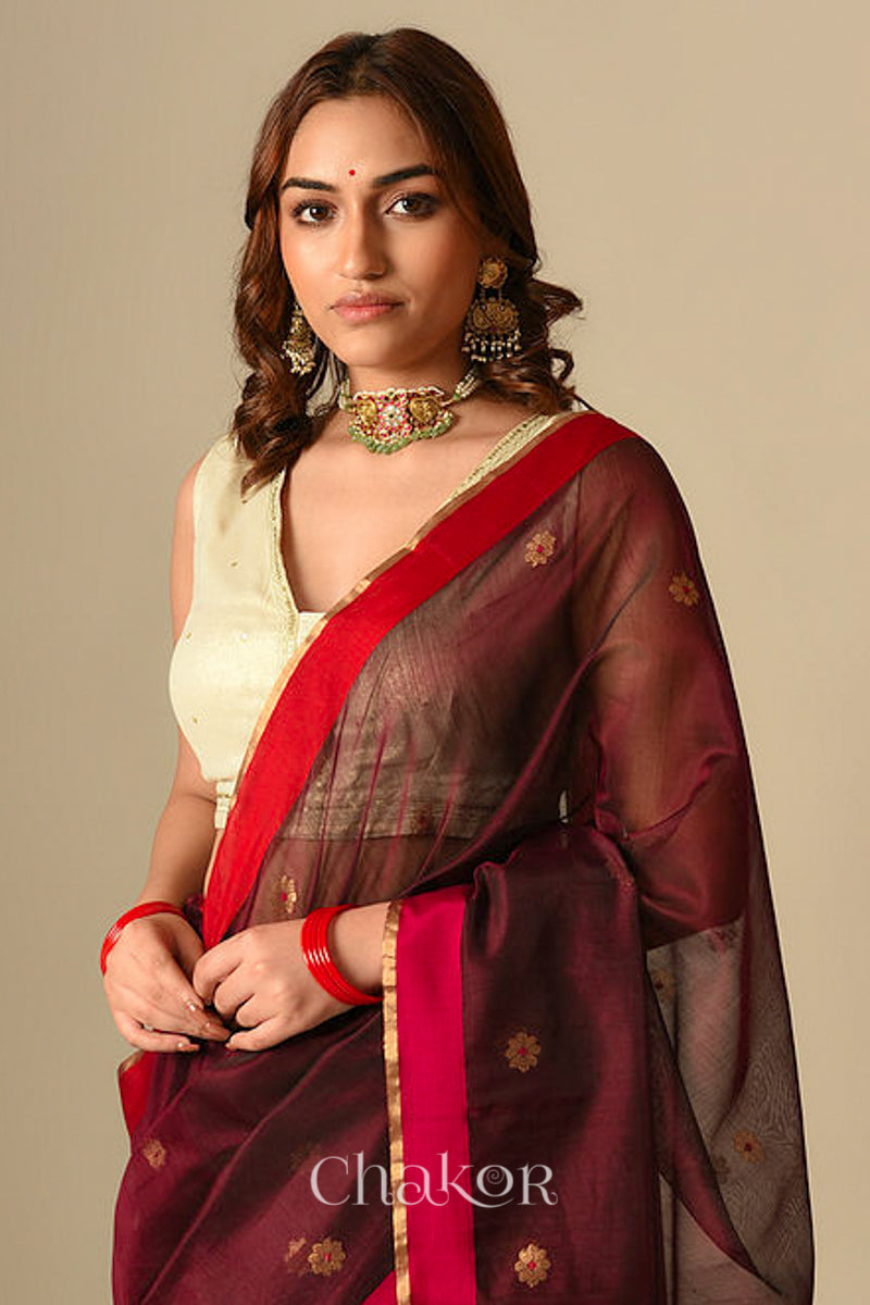 Model wearing Maroon Chanderi silk cotton saree draped to show Ganga Jamuna borders and woven phool butti motifs.
