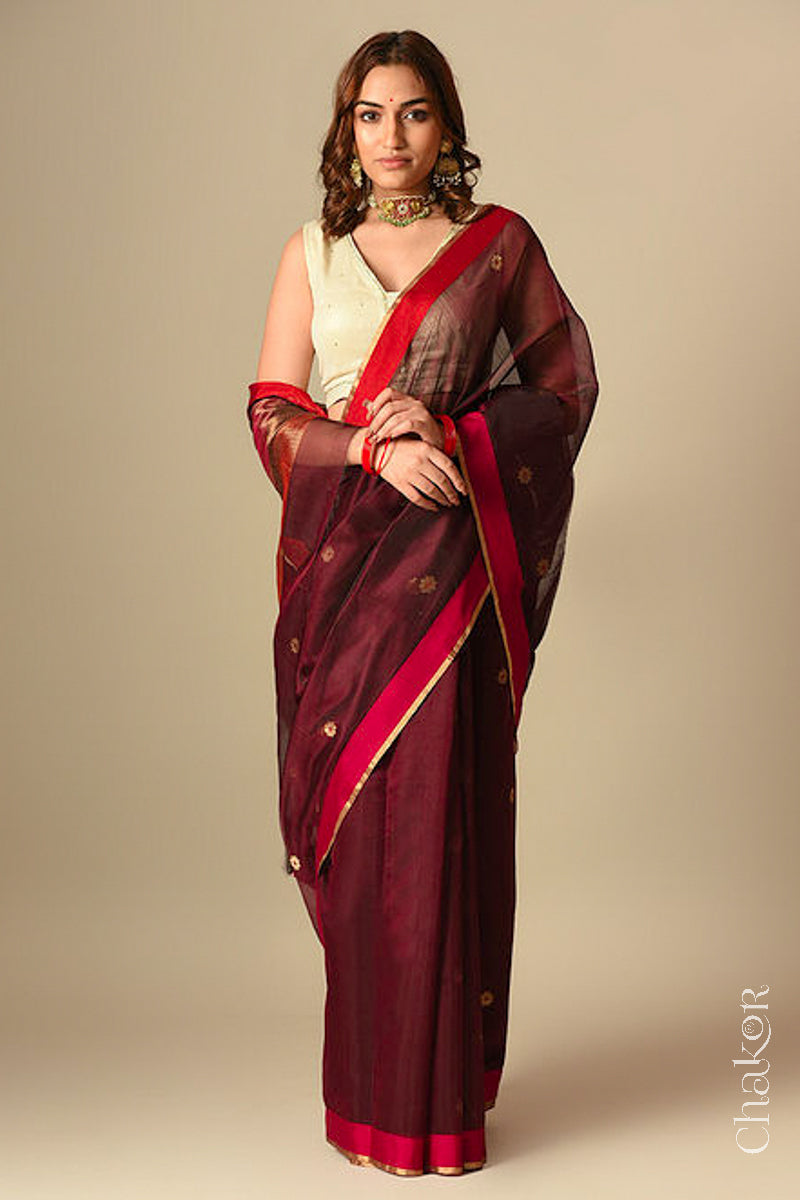 Model wearing a Maroon Chanderi silk cotton saree with Ganga Jamuna borders and tissue-striped pallu.
