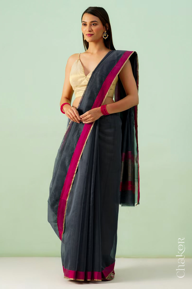 Model wearing a Black Chanderi silk cotton saree with tissue pallu and Ganga Jamuna borders, handwoven in Chanderi.
