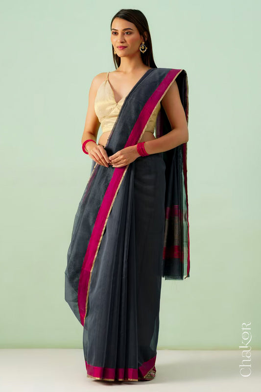 Model wearing a Black Chanderi silk cotton saree with tissue pallu and Ganga Jamuna borders, handwoven in Chanderi.
