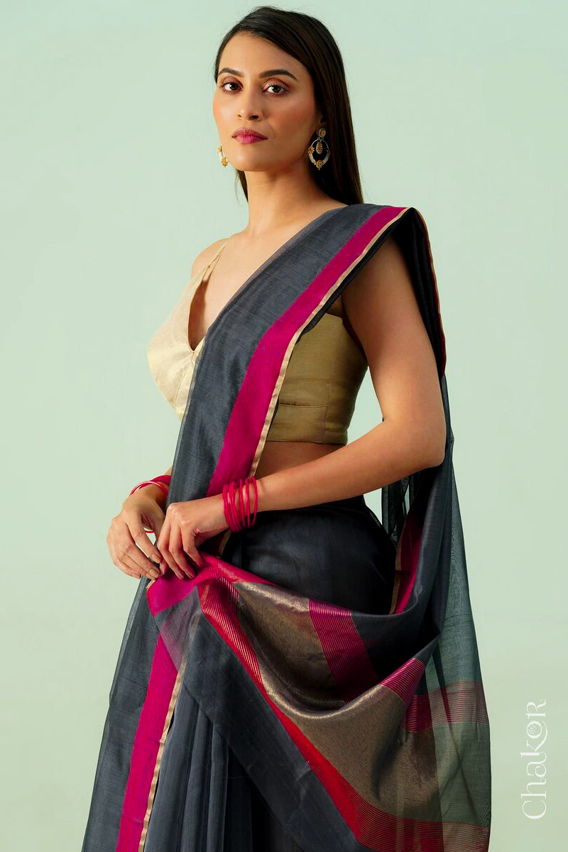 Model wearing a Black Chanderi silk cotton saree with tissue pallu and Ganga Jamuna borders, handwoven in Chanderi.
