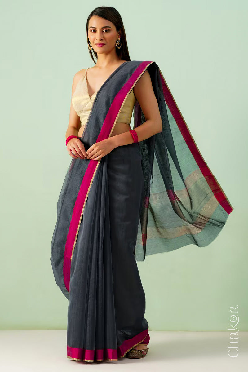 Model wearing a Black Chanderi silk cotton saree with tissue pallu and Ganga Jamuna borders, handwoven in Chanderi.
