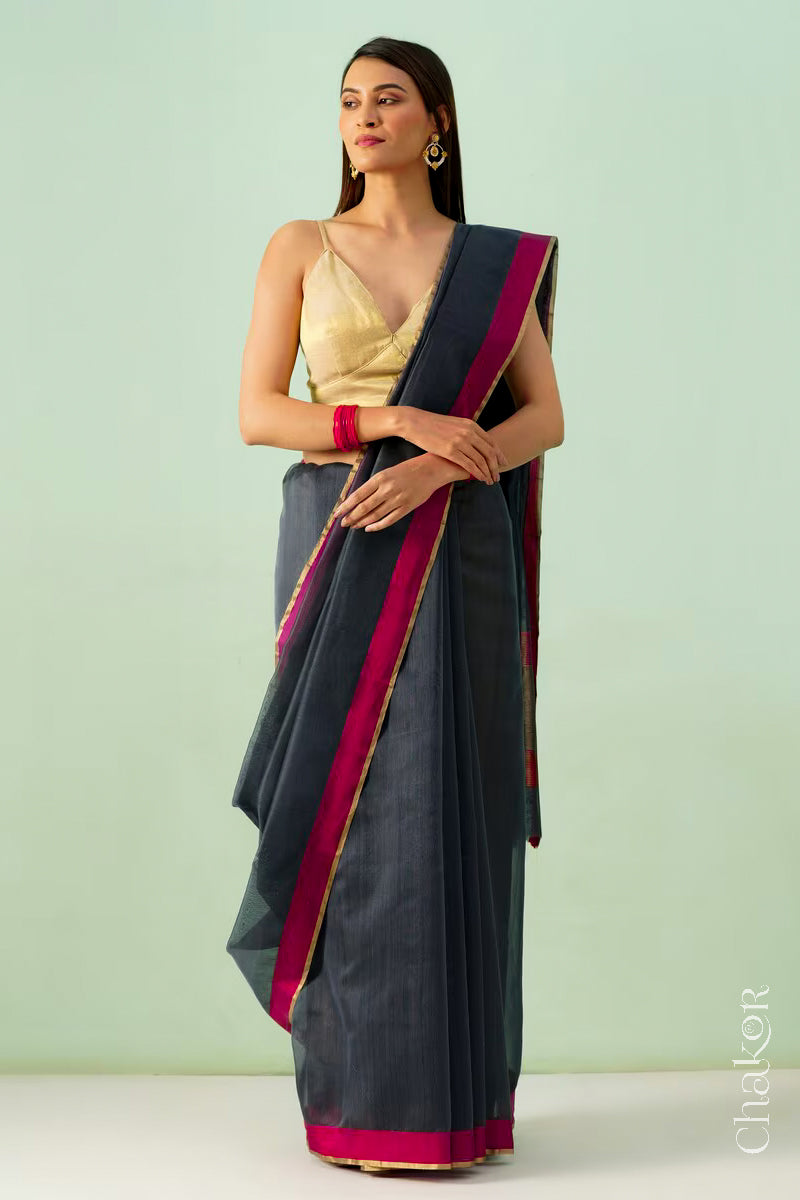Model wearing a Black Chanderi silk cotton saree with tissue pallu and Ganga Jamuna borders, handwoven in Chanderi.
