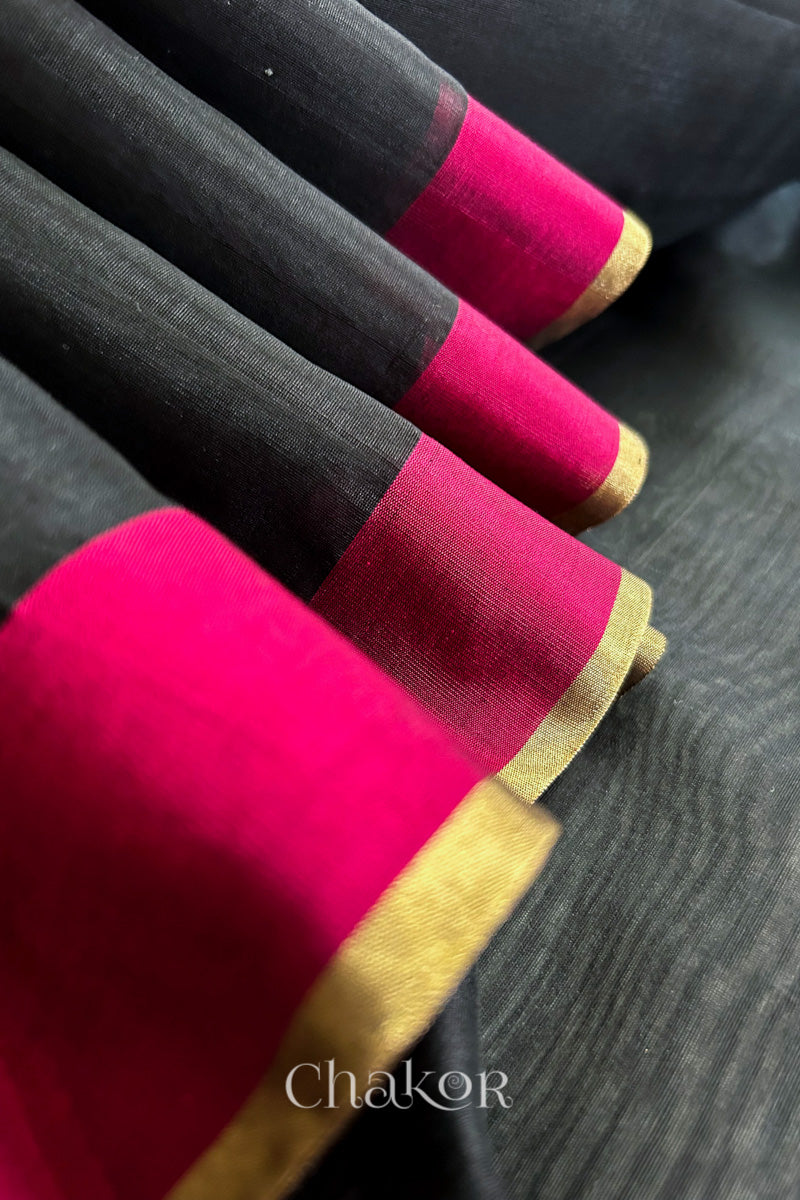 Close-up of the woven texture of Black Chanderi silk cotton fabric.
