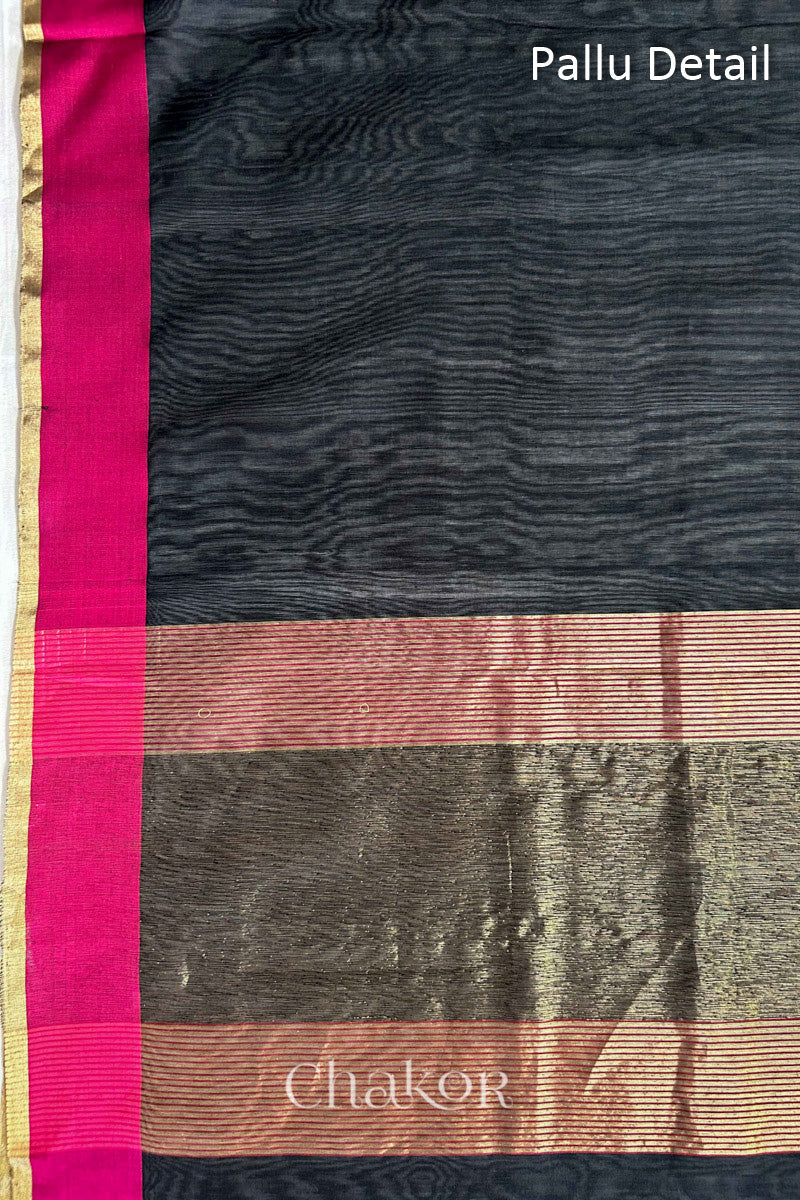 Close-up of the tissue pallu on a Black Chanderi silk cotton saree, showing the woven texture.
