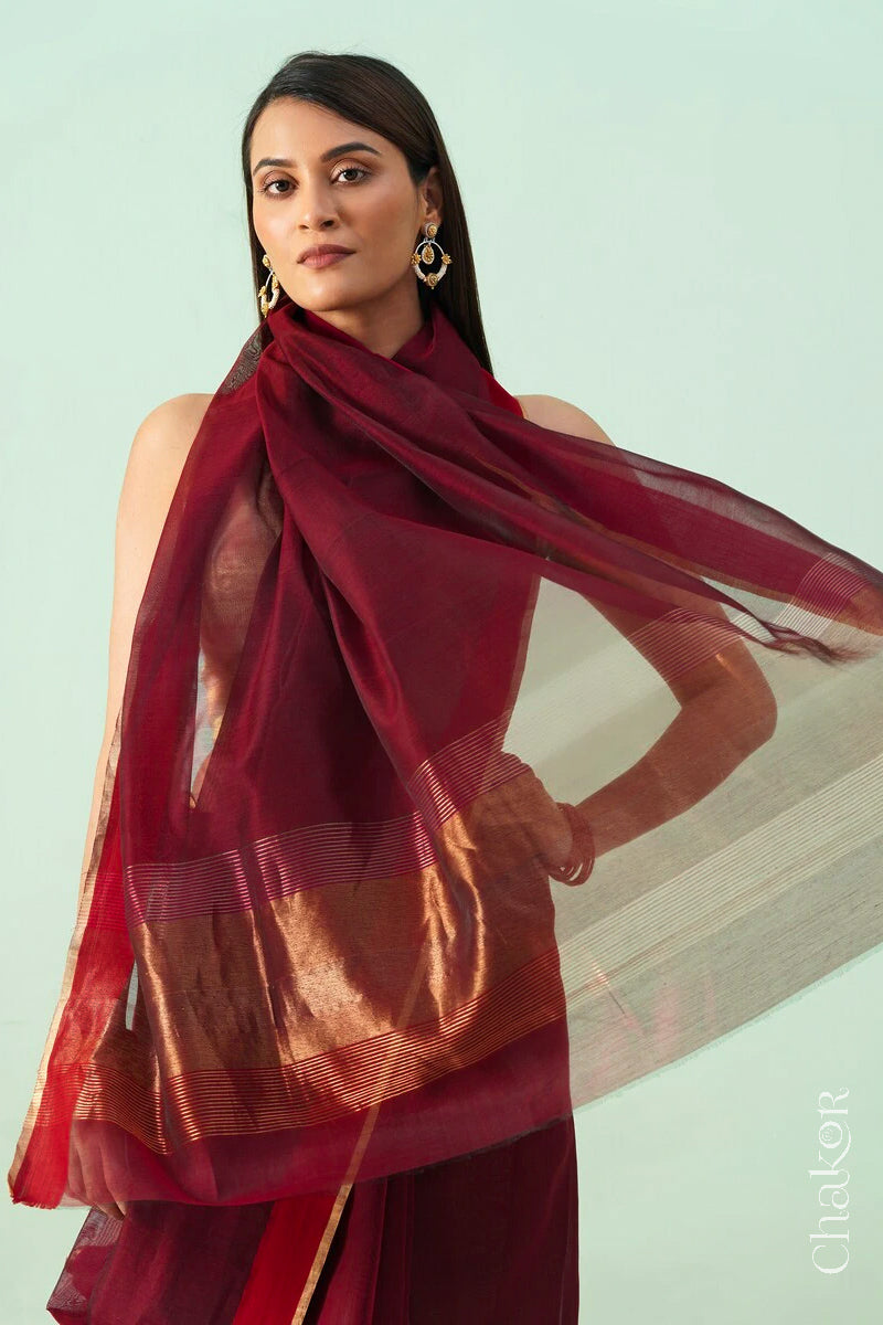 Model wearing a Maroon Chanderi silk cotton saree with tissue pallu and Ganga Jamuna borders, handwoven in Chanderi.
