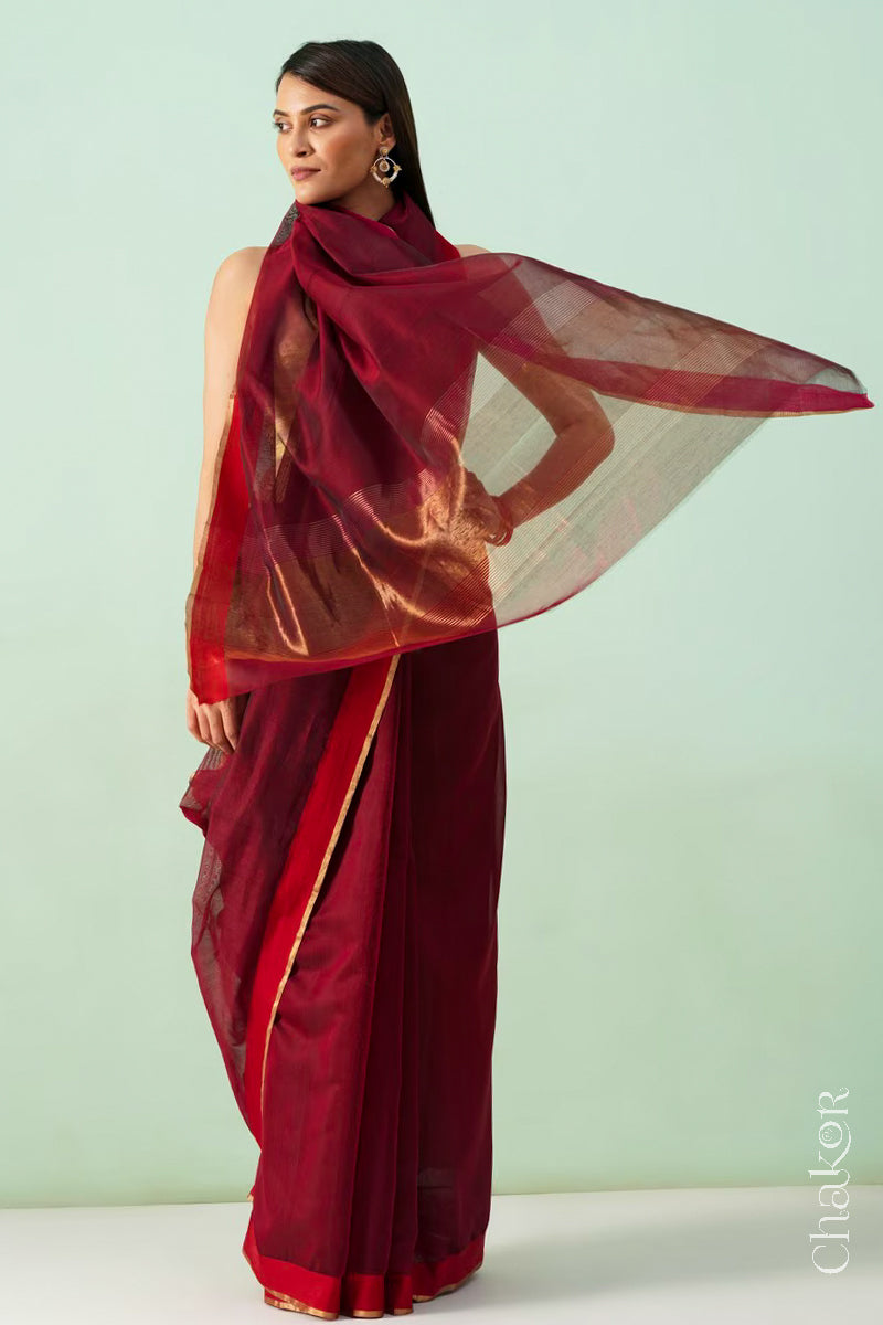 Model wearing a Maroon Chanderi silk cotton saree with tissue pallu and Ganga Jamuna borders, handwoven in Chanderi.
