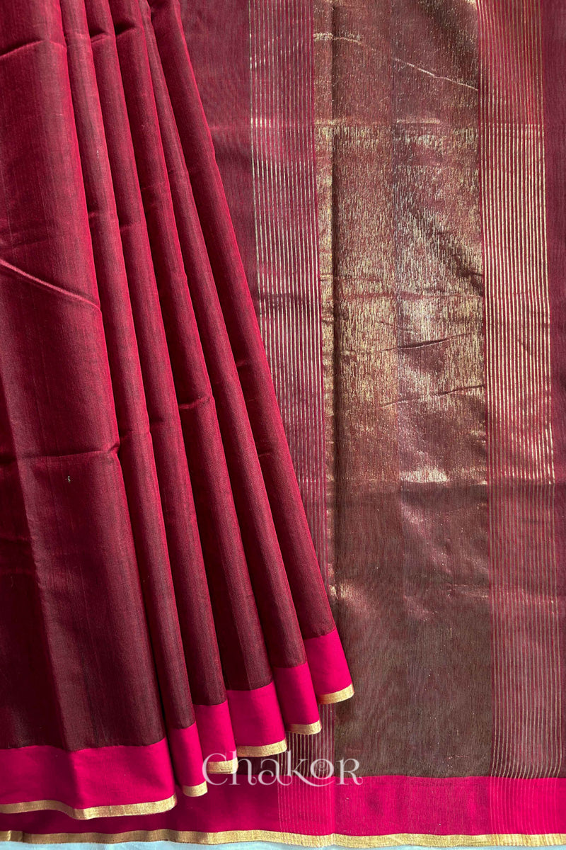 Flatshot of pleats on a Maroon Chanderi silk cotton saree showing the woven pattern and soft drape.
