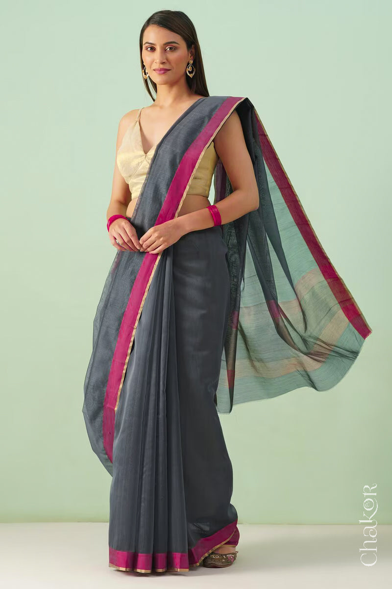 Model wearing a Grey Chanderi silk cotton saree with tissue pallu and Ganga Jamuna borders, handwoven in Chanderi.
