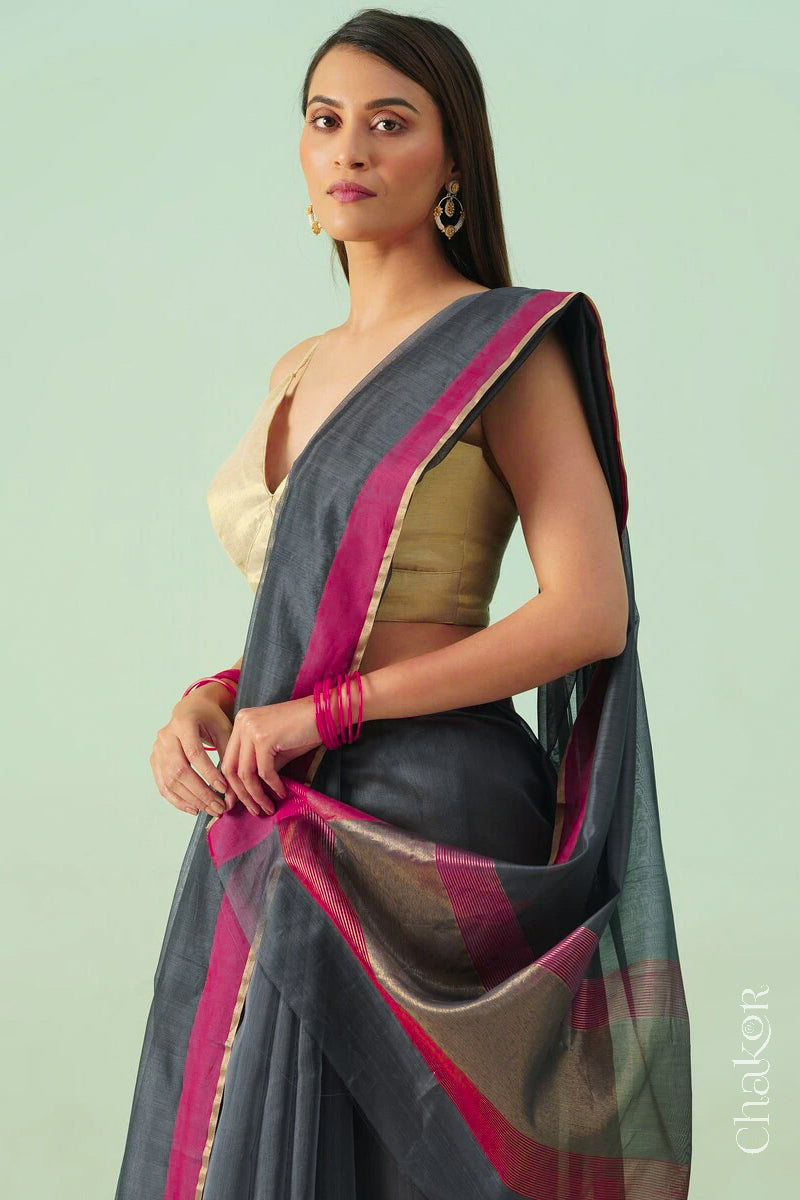 Model wearing a Grey Chanderi silk cotton saree with tissue pallu and Ganga Jamuna borders, handwoven in Chanderi.
