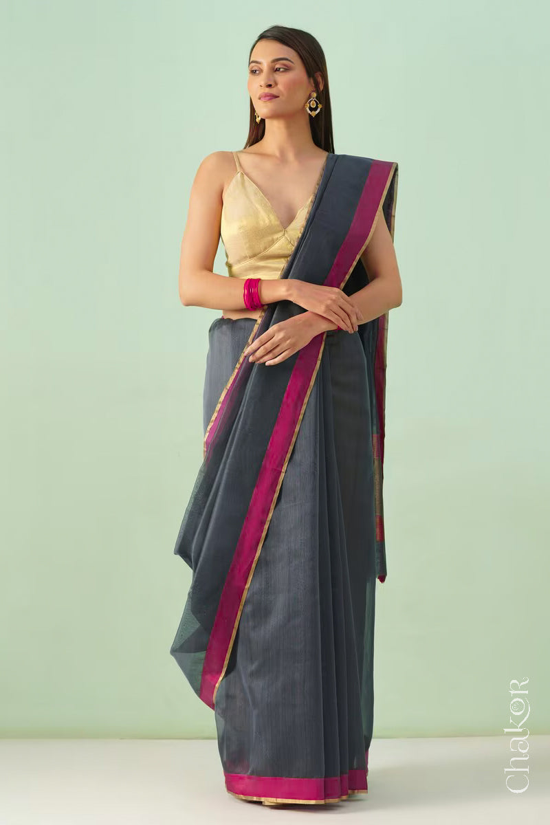 Model wearing a Grey Chanderi silk cotton saree with tissue pallu and Ganga Jamuna borders, handwoven in Chanderi.
