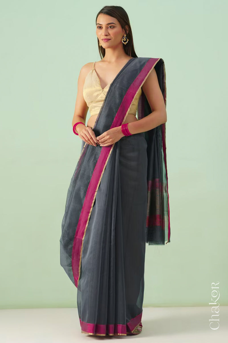 Model wearing a Grey Chanderi silk cotton saree with tissue pallu and Ganga Jamuna borders, handwoven in Chanderi.
