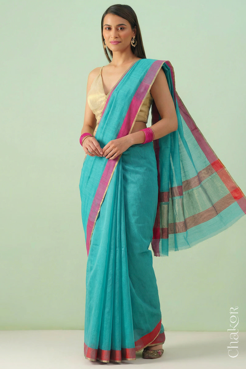 Woman wearing Handloom Sea Blue Chanderi Silk Cotton Saree with ganga jamuna borders and tissue pallu.