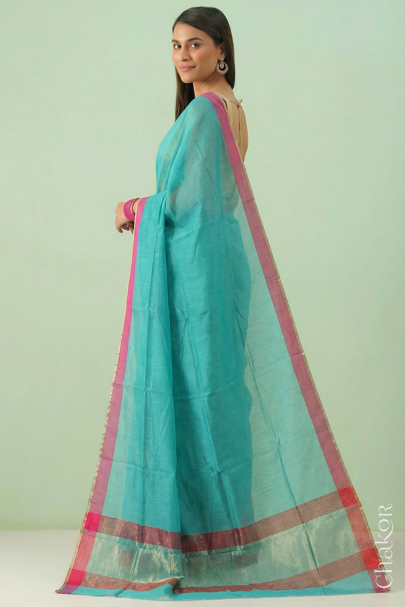 Woman wearing Handloom Sea Blue Chanderi Silk Cotton Saree with ganga jamuna borders and tissue pallu.