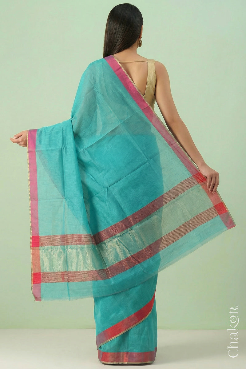 Woman wearing Handloom Sea Blue Chanderi Silk Cotton Saree with ganga jamuna borders and tissue pallu.