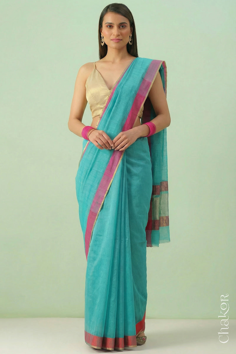 Woman wearing Handloom Sea Blue Chanderi Silk Cotton Saree with ganga jamuna borders and tissue pallu.