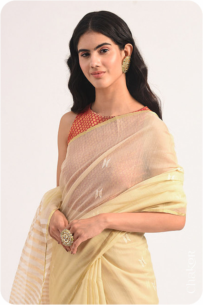 Chakor's Cream Handloom Silk Cotton Saree with woven tissue pallu & delicate buttis.