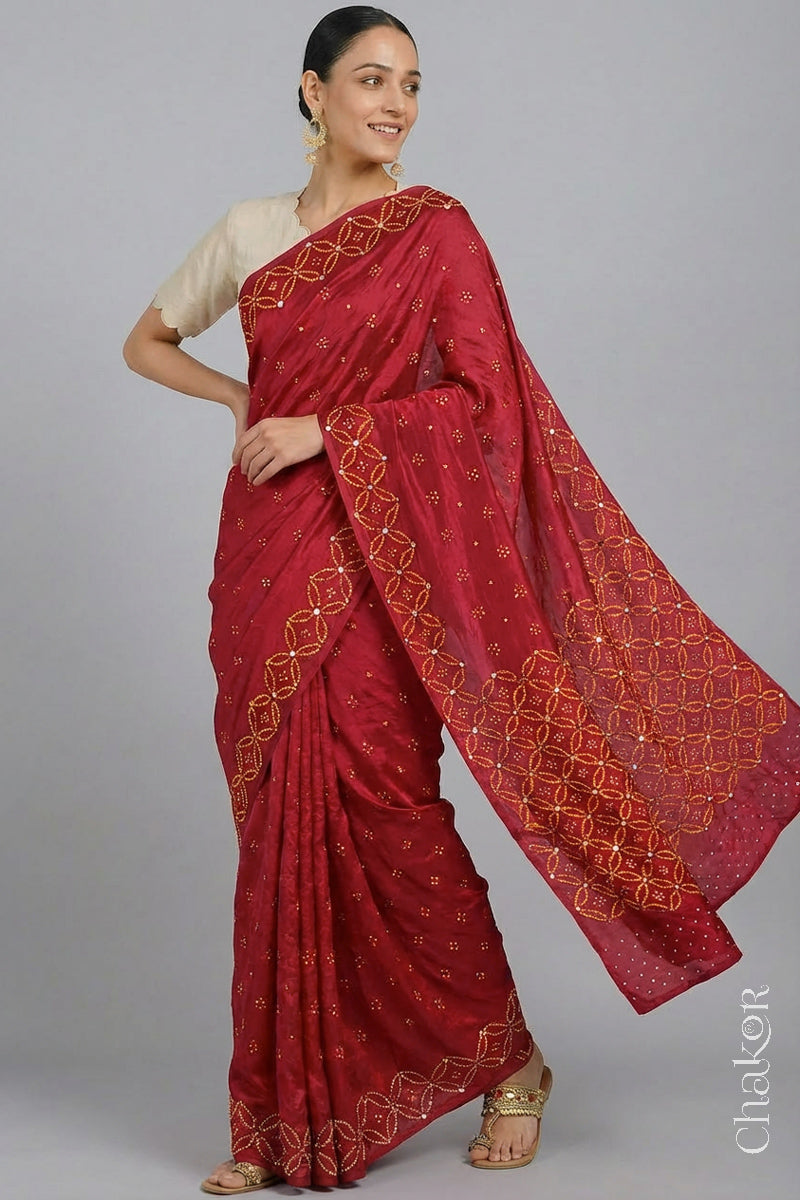 Model wearing Red Bandhani Mulberry Silk Saree handcrafted with yellow bandhej dots and mirror embroidery.
