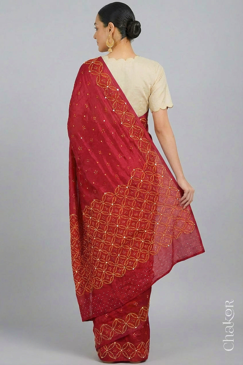 Model wearing Red Bandhani Mulberry Silk Saree handcrafted with yellow bandhej dots and mirror embroidery.