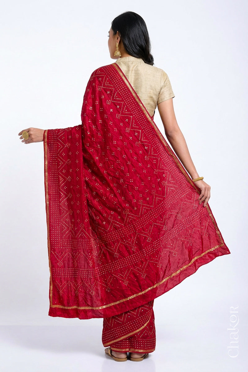 Back view of model wearing Red Bandhani Mulberry Silk Saree, rai bandhej with sequins embroidery.