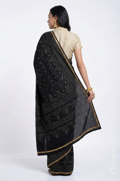 Back view of model wearing Black Bandhani Mulberry Silk Saree with sequins embroidery.