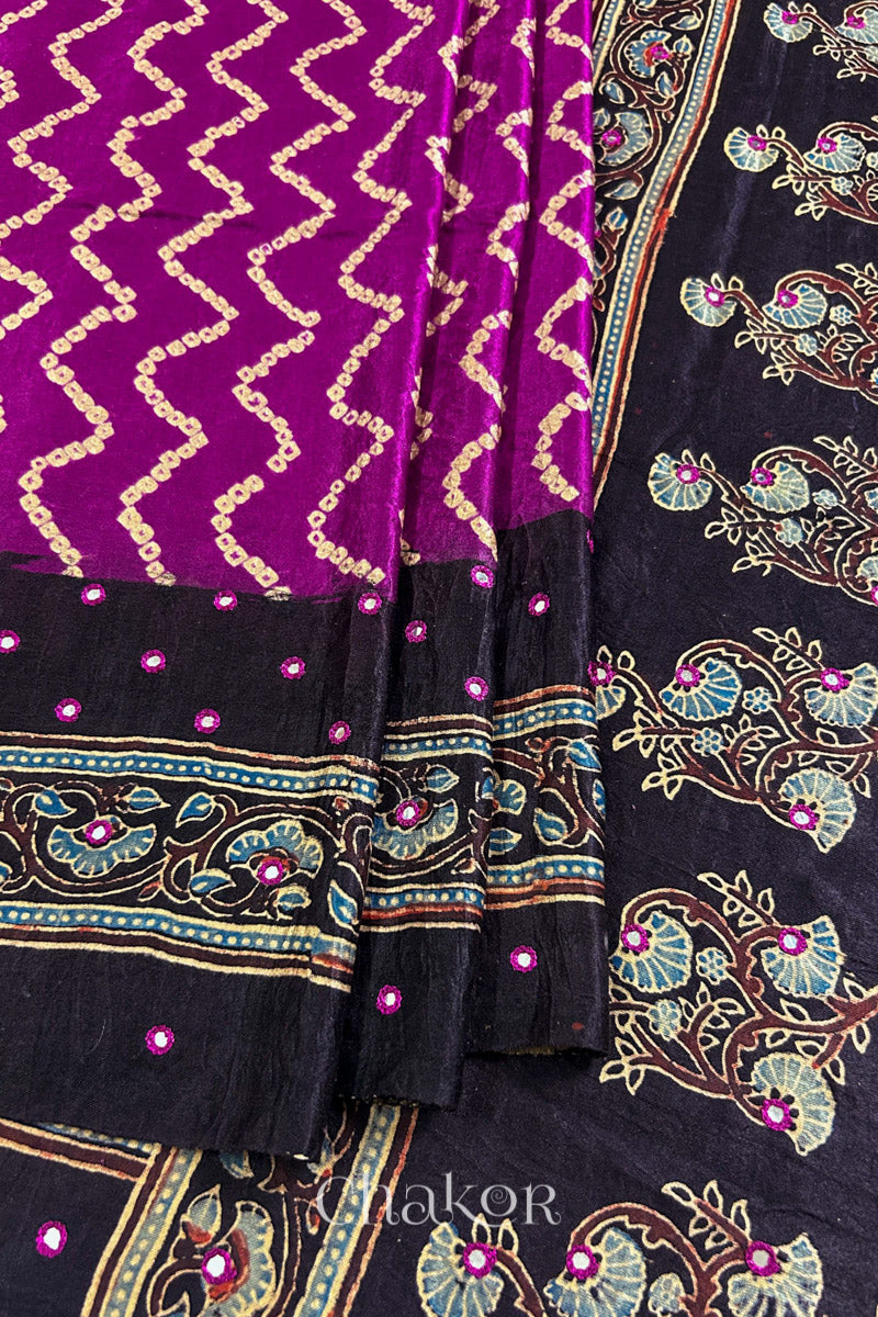 Close up of Magenta Bandhani Saree with Black Ajrakh printed border and pallu in pure gaji silk with traditional bandhej tie-dye & mirror work, handcrafted in Kutch. 