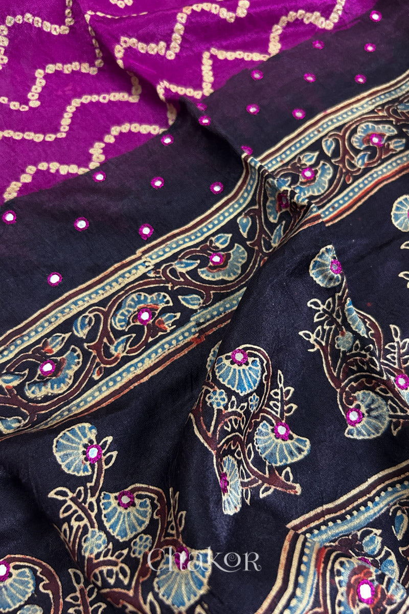Close up of Magenta Bandhani Saree with Black Ajrakh printed border and pallu in pure gaji silk with traditional bandhej tie-dye & mirror work, handcrafted in Kutch. 