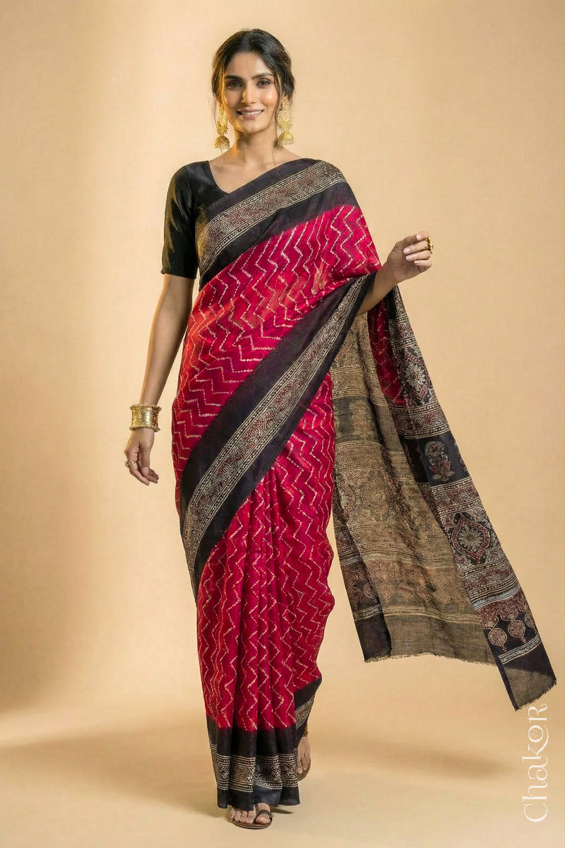 Woman wearing Red Bandhani Saree with Black Ajrakh printed border and pallu in pure gaji silk with traditional bandhej tie-dye, handcrafted in Kutch. 