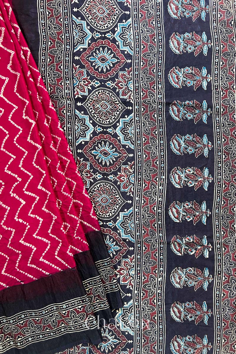 Close up of Red Bandhani Saree with Black Ajrakh printed border and pallu in pure gaji silk with traditional bandhej tie-dye, handcrafted in Kutch. 