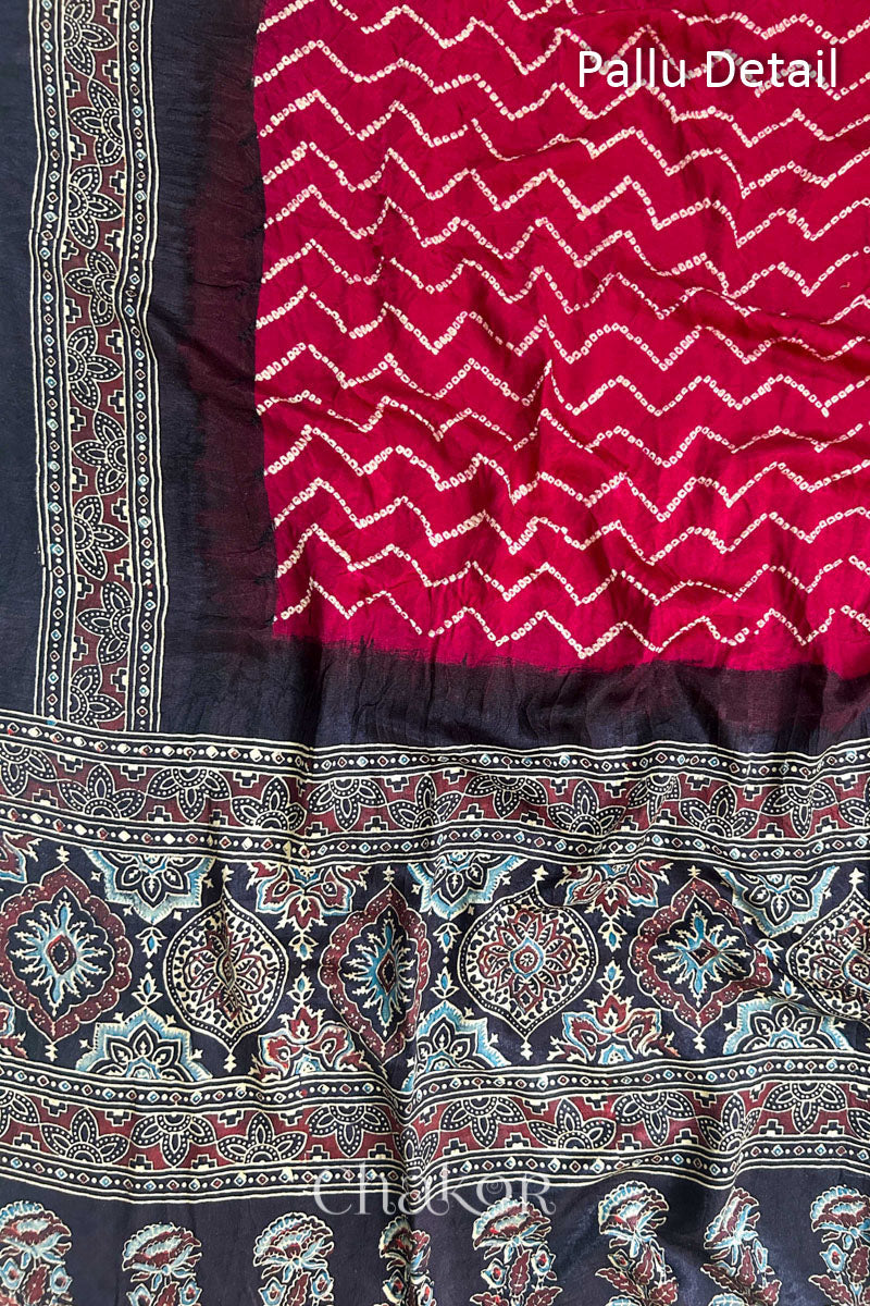 Close up of Red Bandhani Saree with Black Ajrakh printed border and pallu in pure gaji silk with traditional bandhej tie-dye, handcrafted in Kutch. 