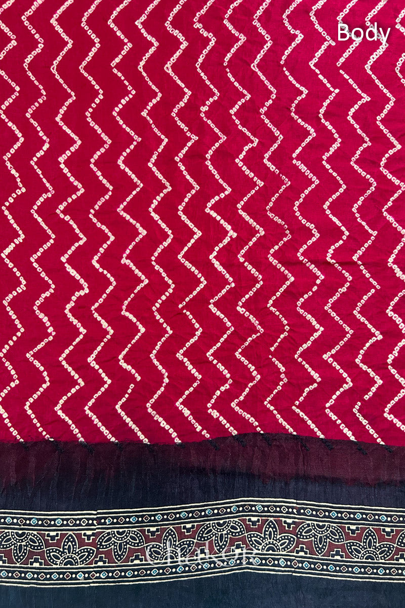 Close up of Red Bandhani Saree with Black Ajrakh printed border and pallu in pure gaji silk with traditional bandhej tie-dye, handcrafted in Kutch. 