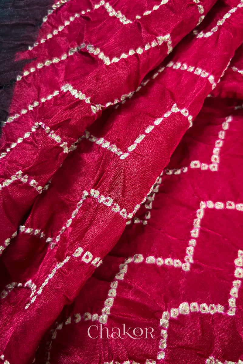 Close up of Red Bandhani Saree with Black Ajrakh printed border and pallu in pure gaji silk with traditional bandhej tie-dye, handcrafted in Kutch. 