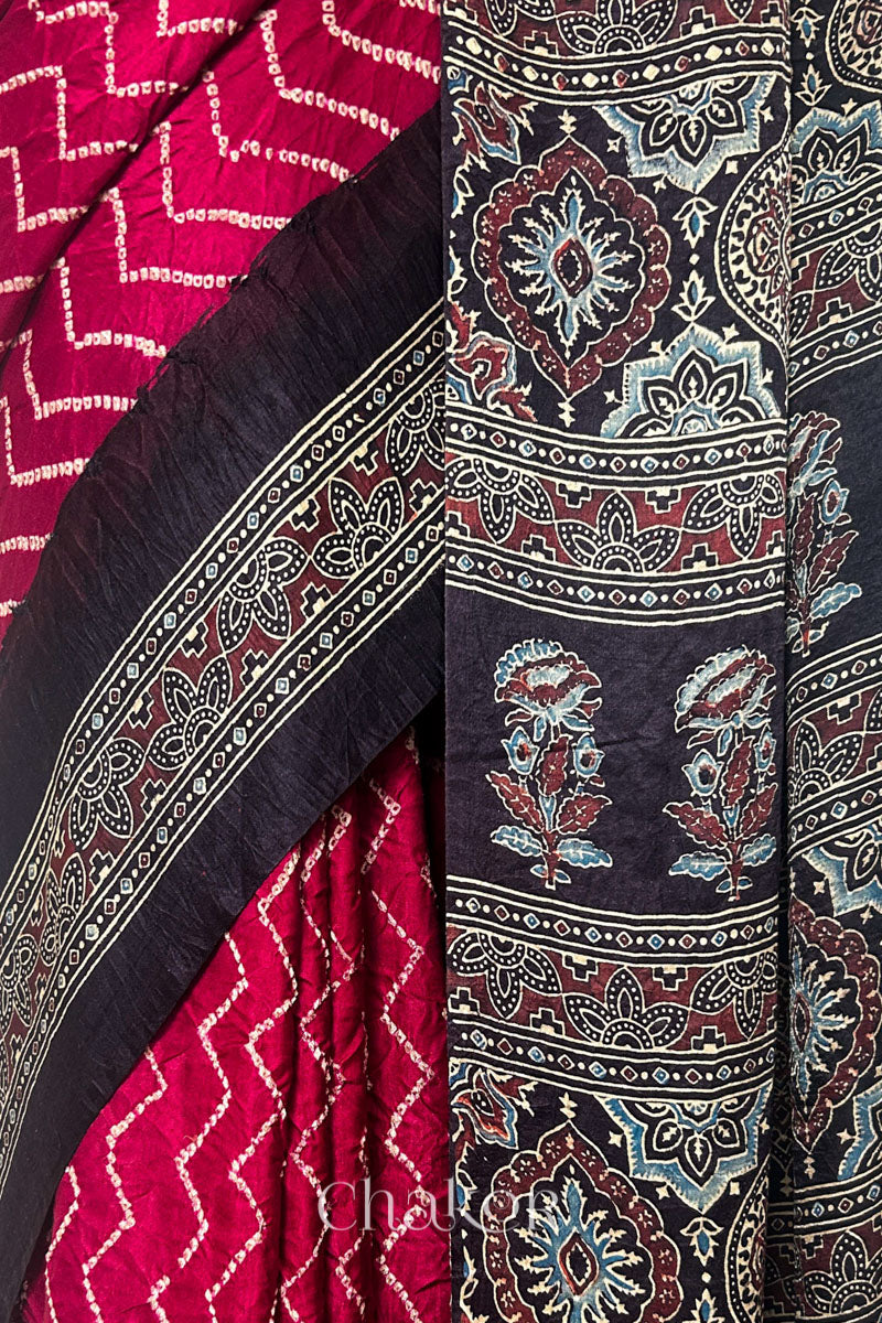 Close up of Red Bandhani Saree with Black Ajrakh printed border and pallu in pure gaji silk with traditional bandhej tie-dye, handcrafted in Kutch. 