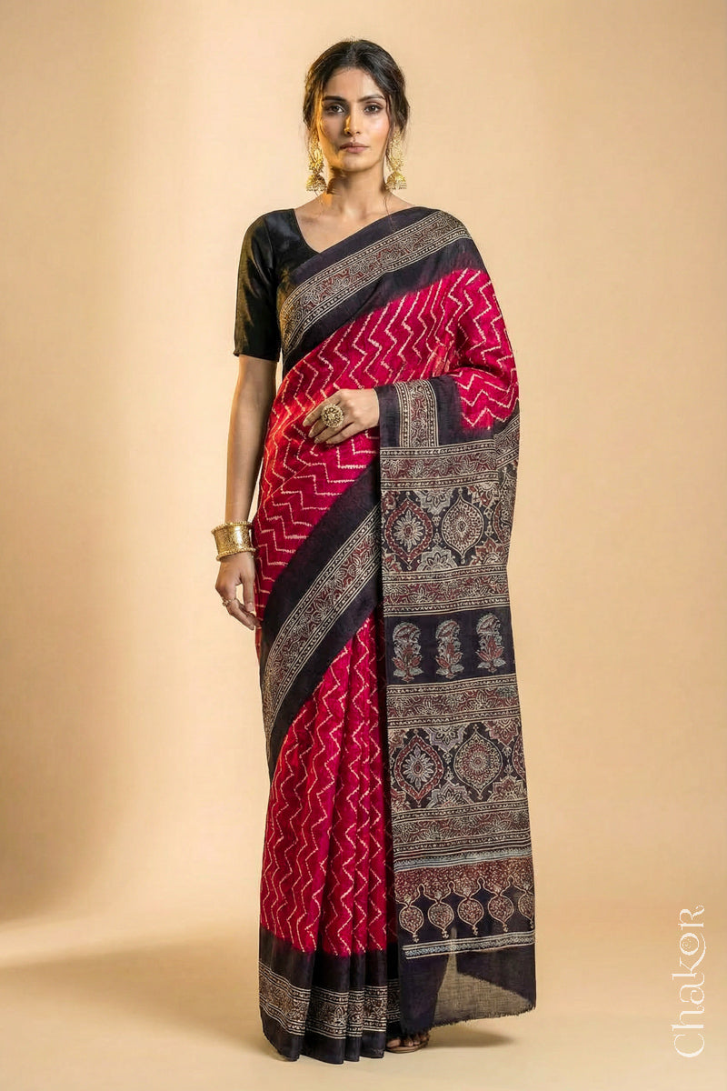 Woman wearing Red Bandhani Saree with Black Ajrakh printed border and pallu in pure gaji silk with traditional bandhej tie-dye, handcrafted in Kutch. 