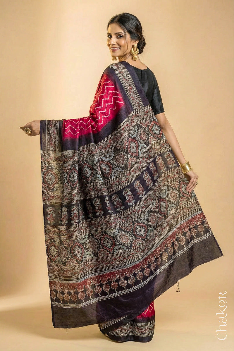 Woman wearing Red Bandhani Saree with Black Ajrakh printed border and pallu in pure gaji silk with traditional bandhej tie-dye, handcrafted in Kutch. 