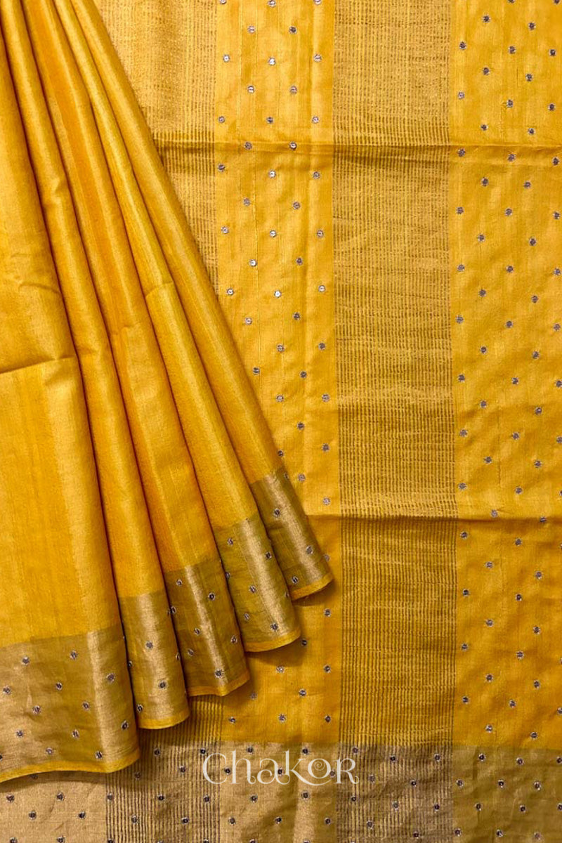 Close up of Yellow tussar silk handloom saree with golden zari border & hand embroidered with  sequins & zari work